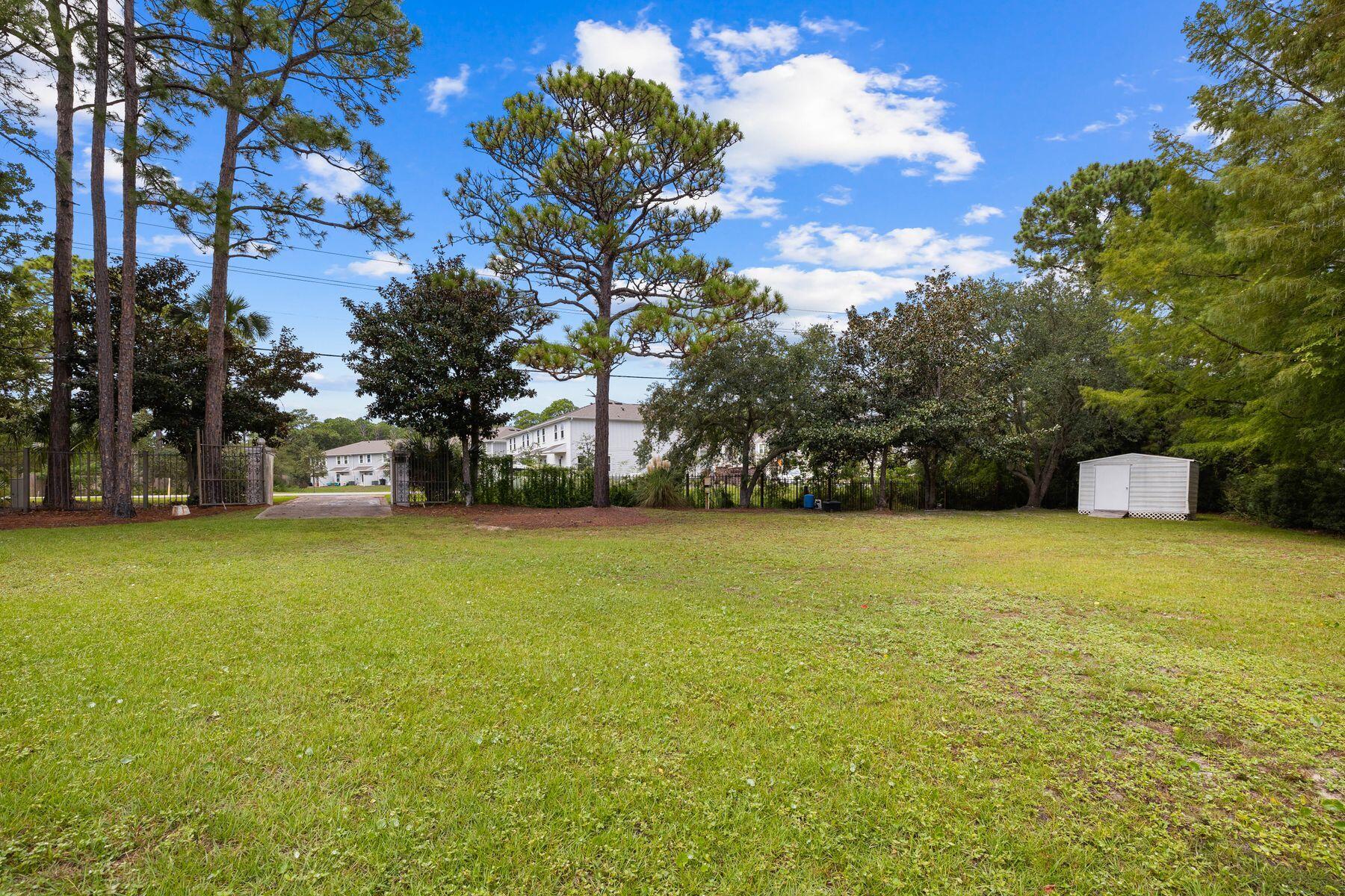 1196 Mack Bayou Road Santa Rosa Beach, FL 32459 - Photo 6 of 19 a view of a street with a building and trees in the background