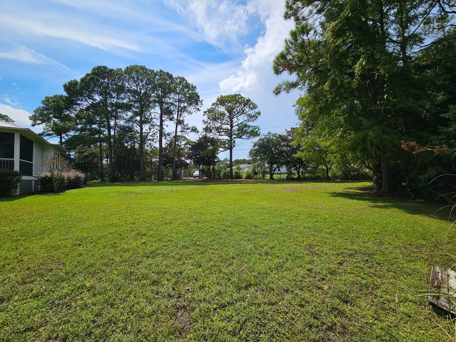 1196 Mack Bayou Road Santa Rosa Beach, FL 32459 - Photo 8 of 19 a view of green field with trees in the background