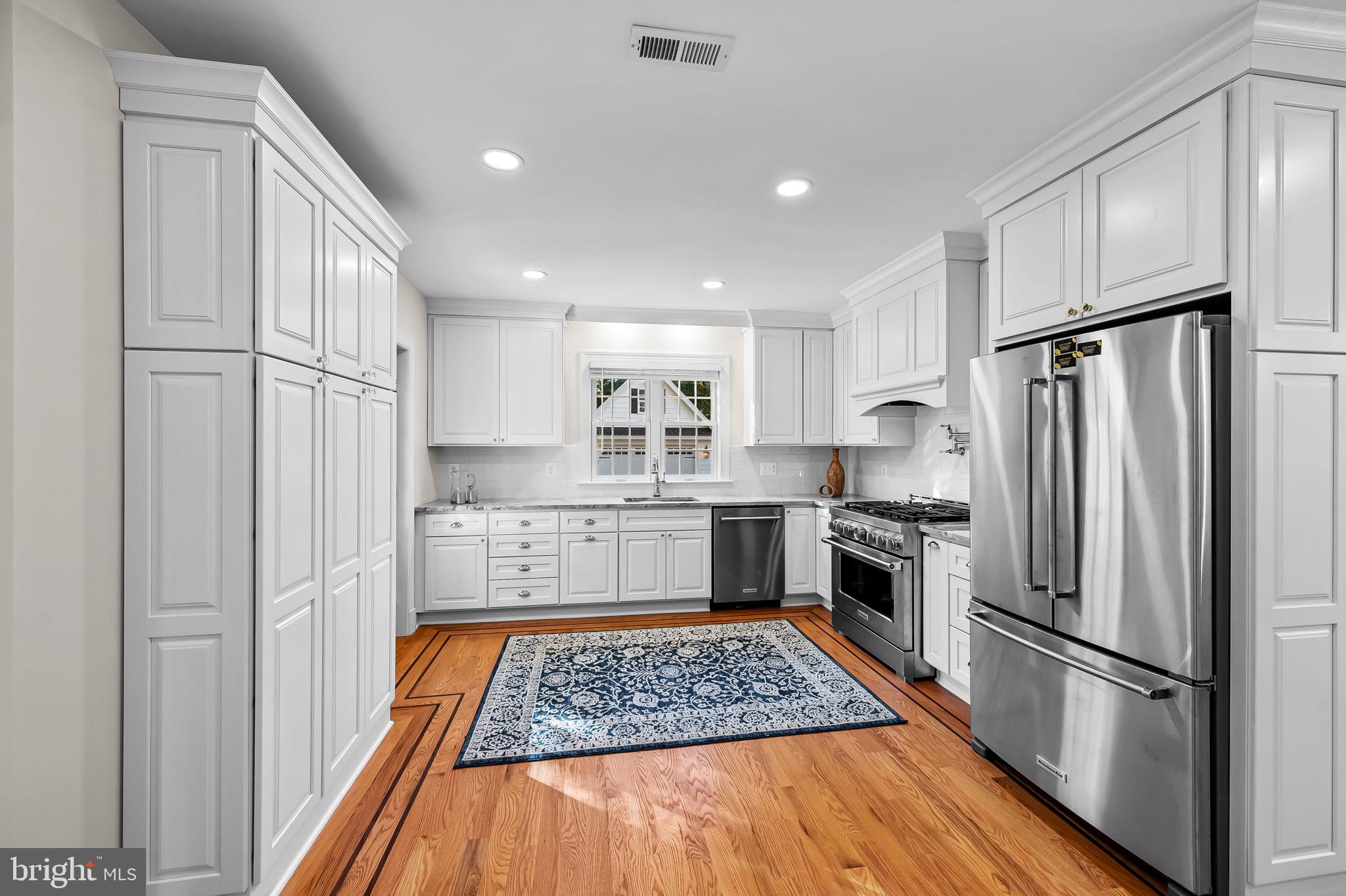 6300 Pinehurst Road Baltimore, MD 21212 - Photo 11 of 34 a kitchen with stainless steel appliances granite countertop a refrigerator stove microwave and cabinets