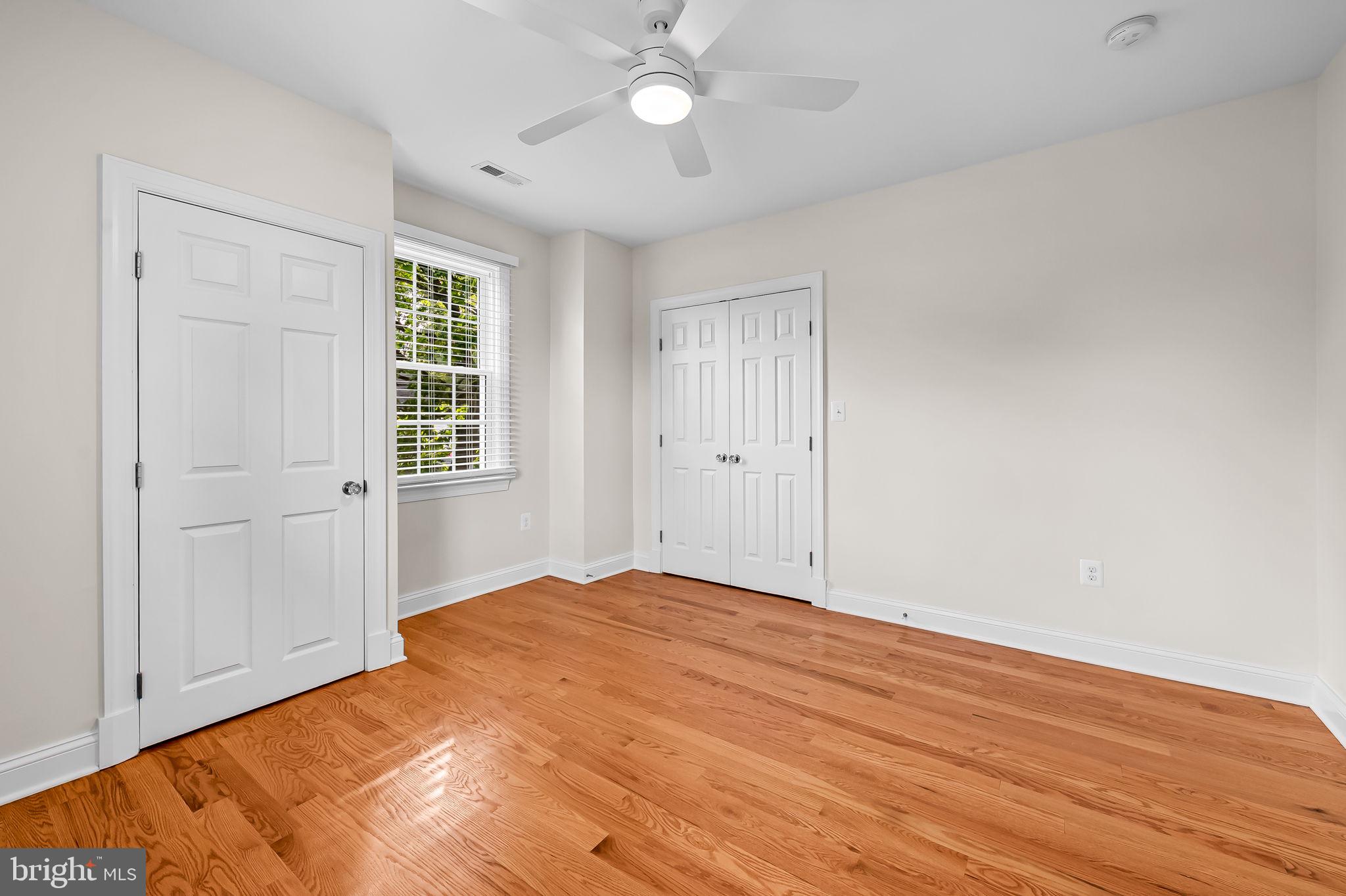 6300 Pinehurst Road Baltimore, MD 21212 - Photo 16 of 34 a view of empty room with wooden floor and fan