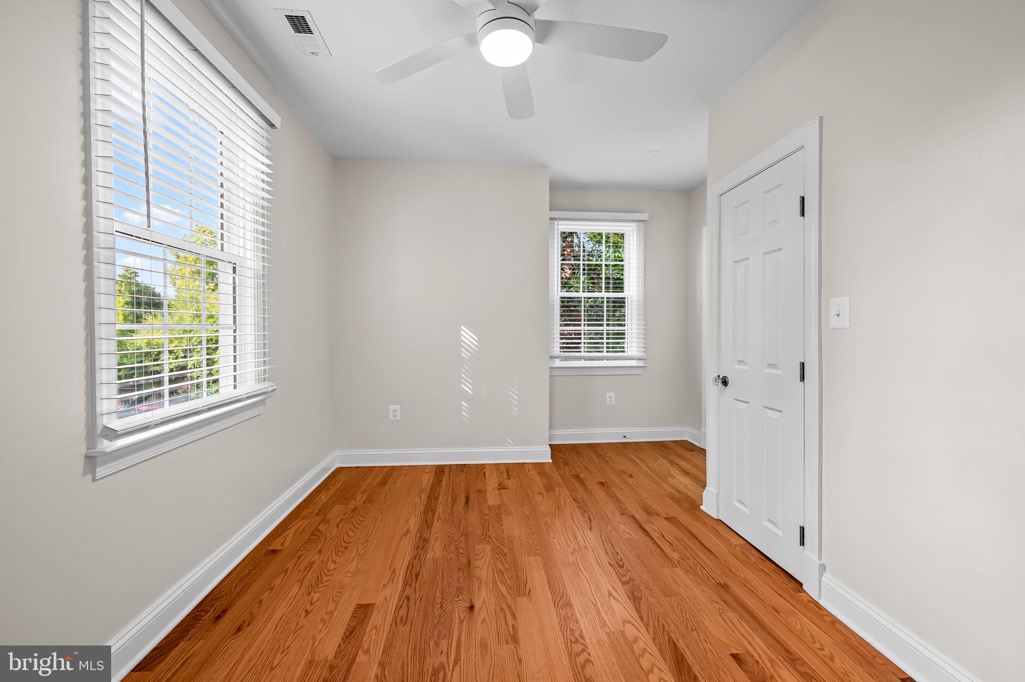 6300 Pinehurst Road Baltimore, MD 21212 - Photo 18 of 34 an empty room with wooden floor and windows
