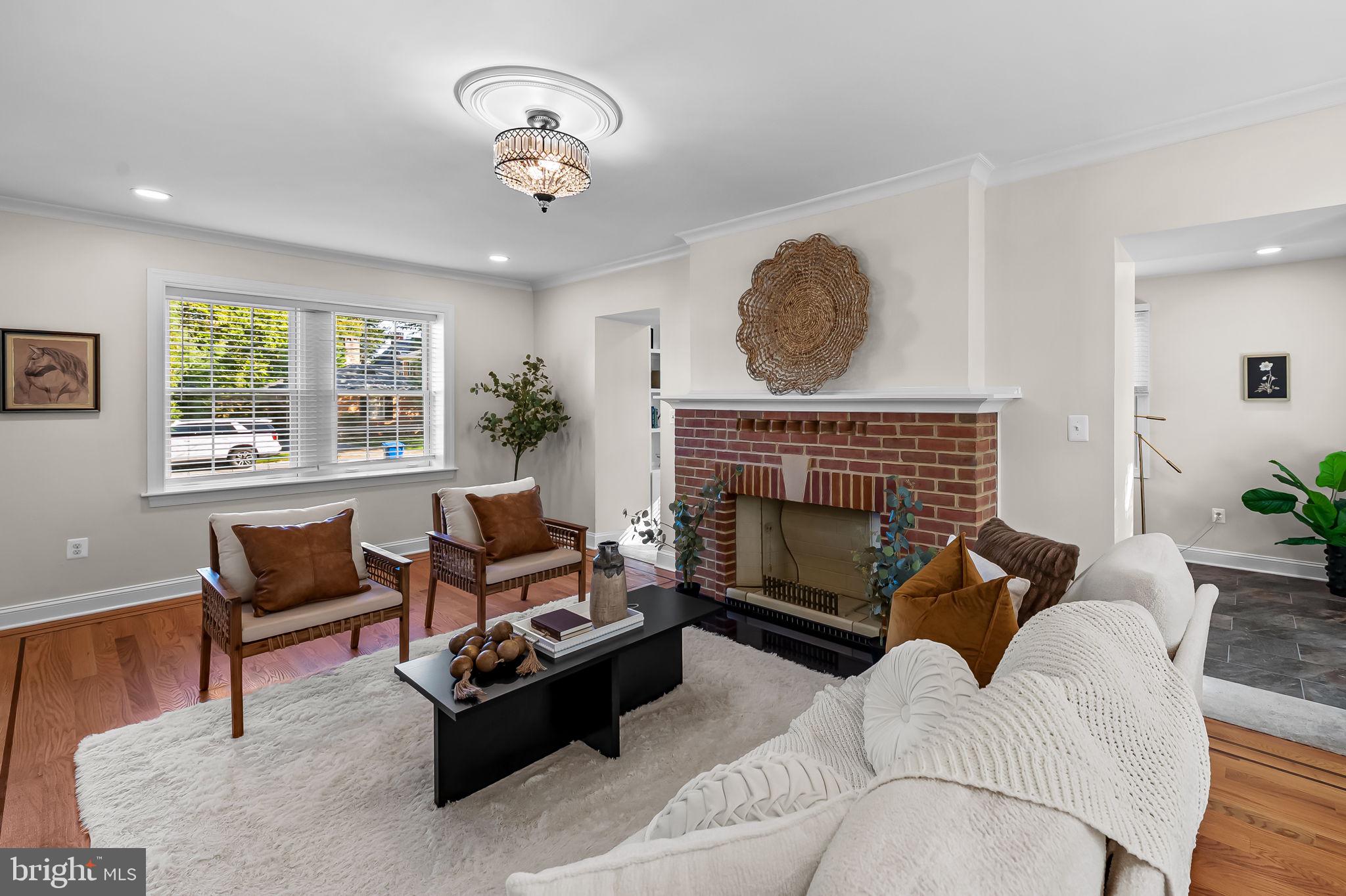 6300 Pinehurst Road Baltimore, MD 21212 - Photo 5 of 34 a living room with furniture a chandelier and a fireplace