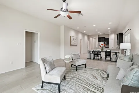 a living room with furniture and kitchen view