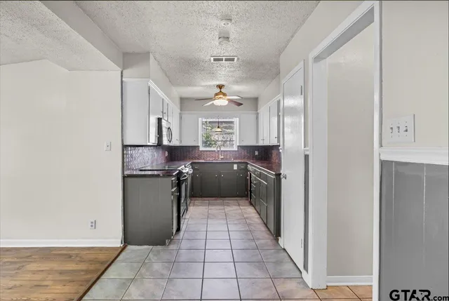 a kitchen with a refrigerator and a sink