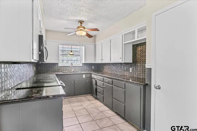 a kitchen with a sink cabinets and window