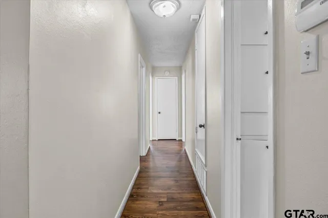 a view of a hallway with wooden floor