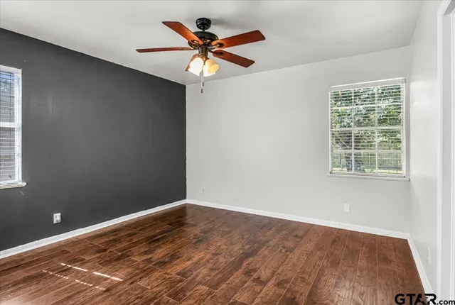 wooden floor in an empty room with a window