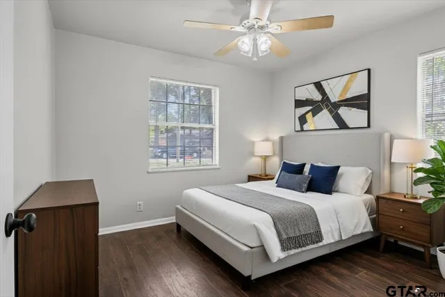 a bedroom with a bed and wooden floor