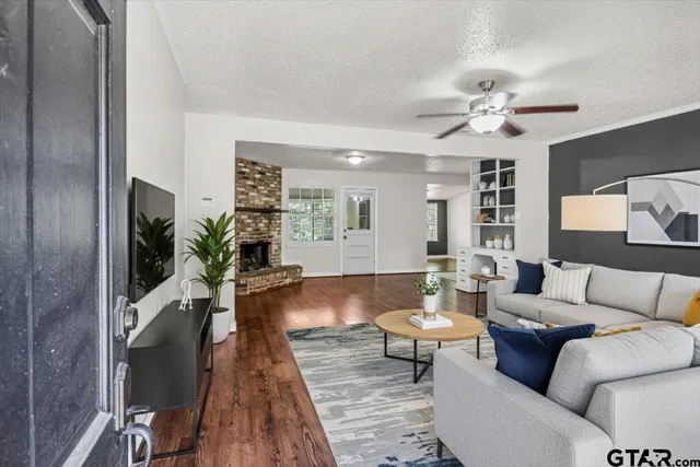 a living room with furniture and a wooden floor