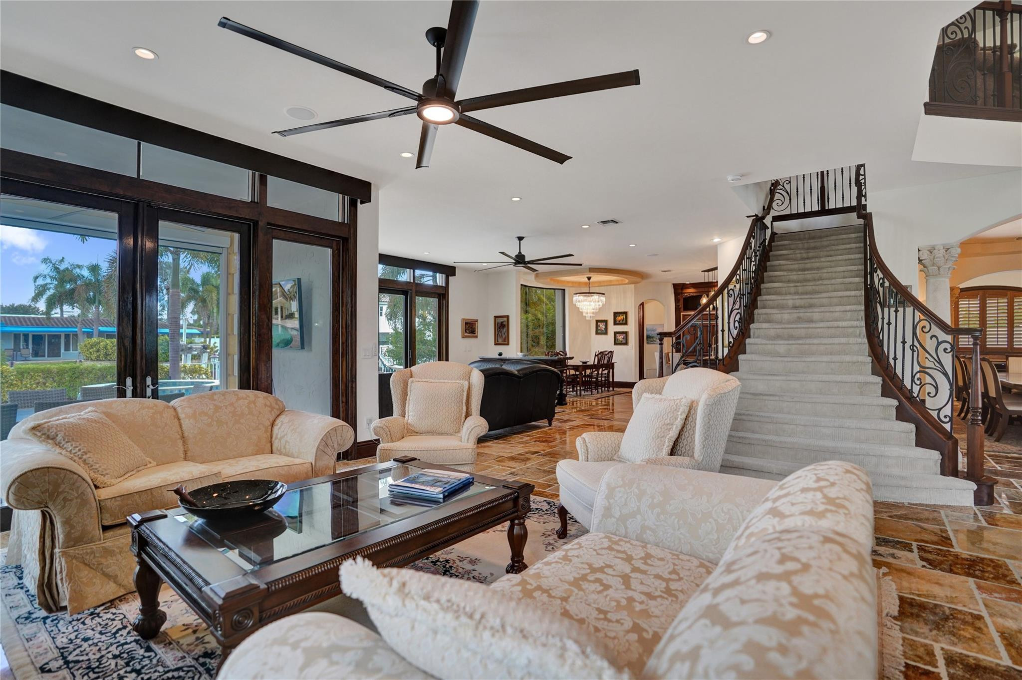 4930 Northeast 27th Terrace Lighthouse Point, FL 33064 - Photo 14 of 51 a living room with furniture ceiling fan and a large window