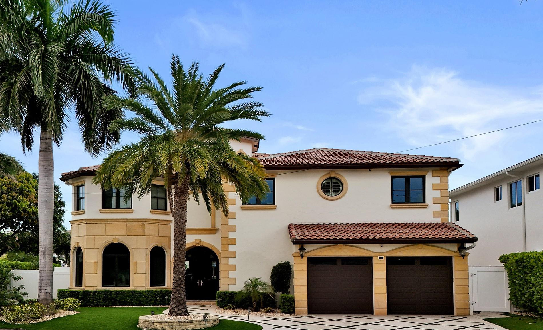 4930 Northeast 27th Terrace Lighthouse Point, FL 33064 - Photo 2 of 51 a house view with a garden space
