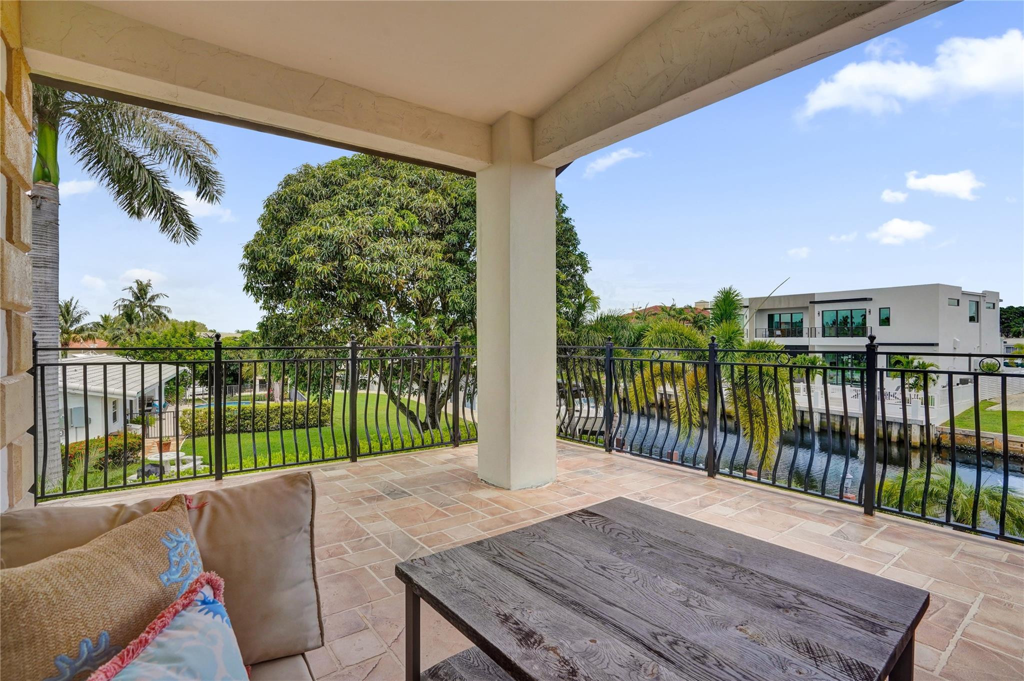 4930 Northeast 27th Terrace Lighthouse Point, FL 33064 - Photo 24 of 51 a balcony with table and chairs