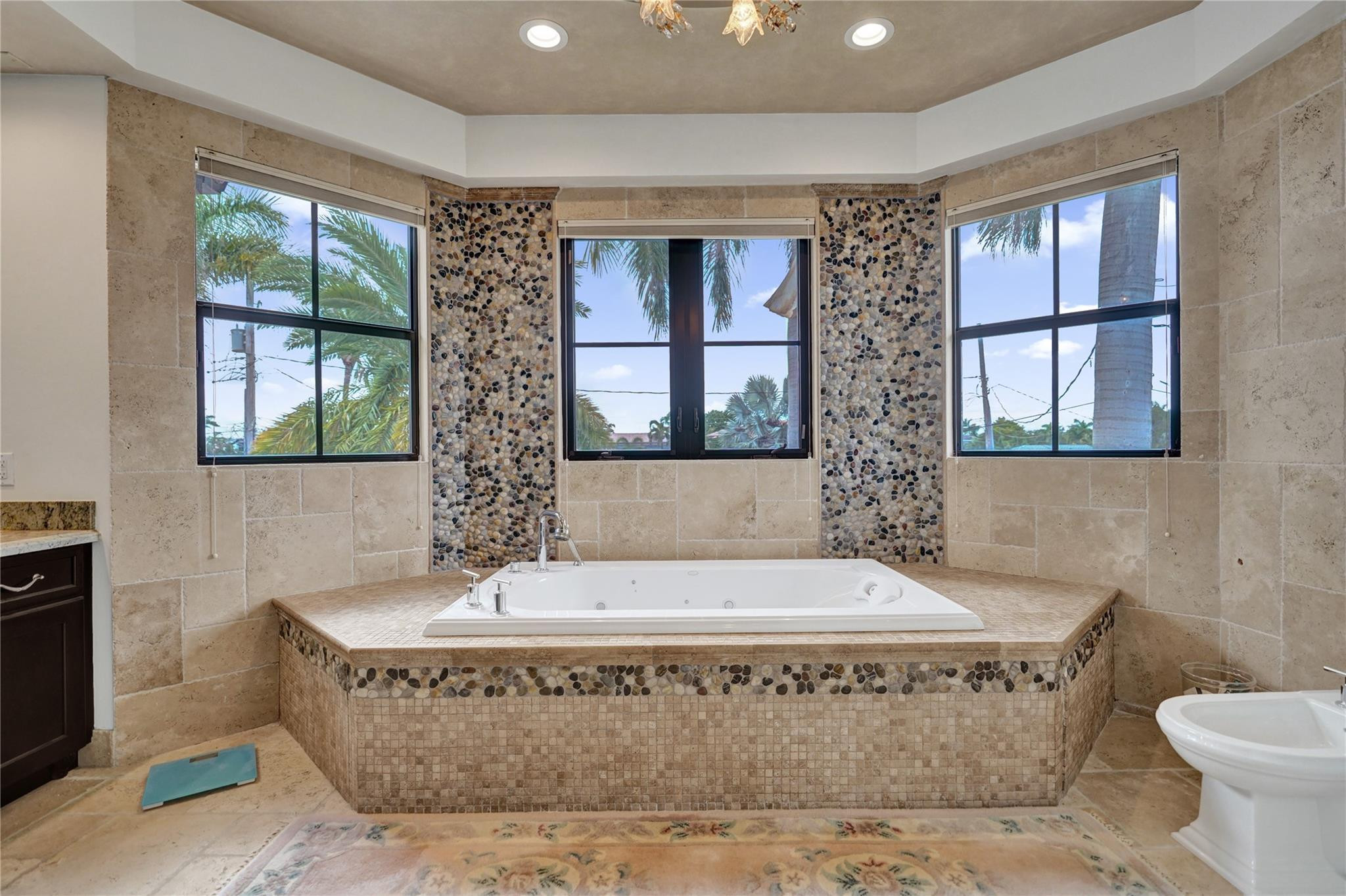 4930 Northeast 27th Terrace Lighthouse Point, FL 33064 - Photo 26 of 51 a bathroom with a bathtub and window