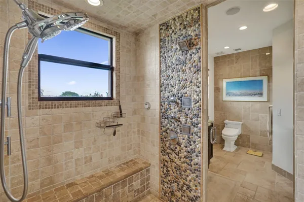 a bathroom with a granite countertop tub a sink and a large mirror