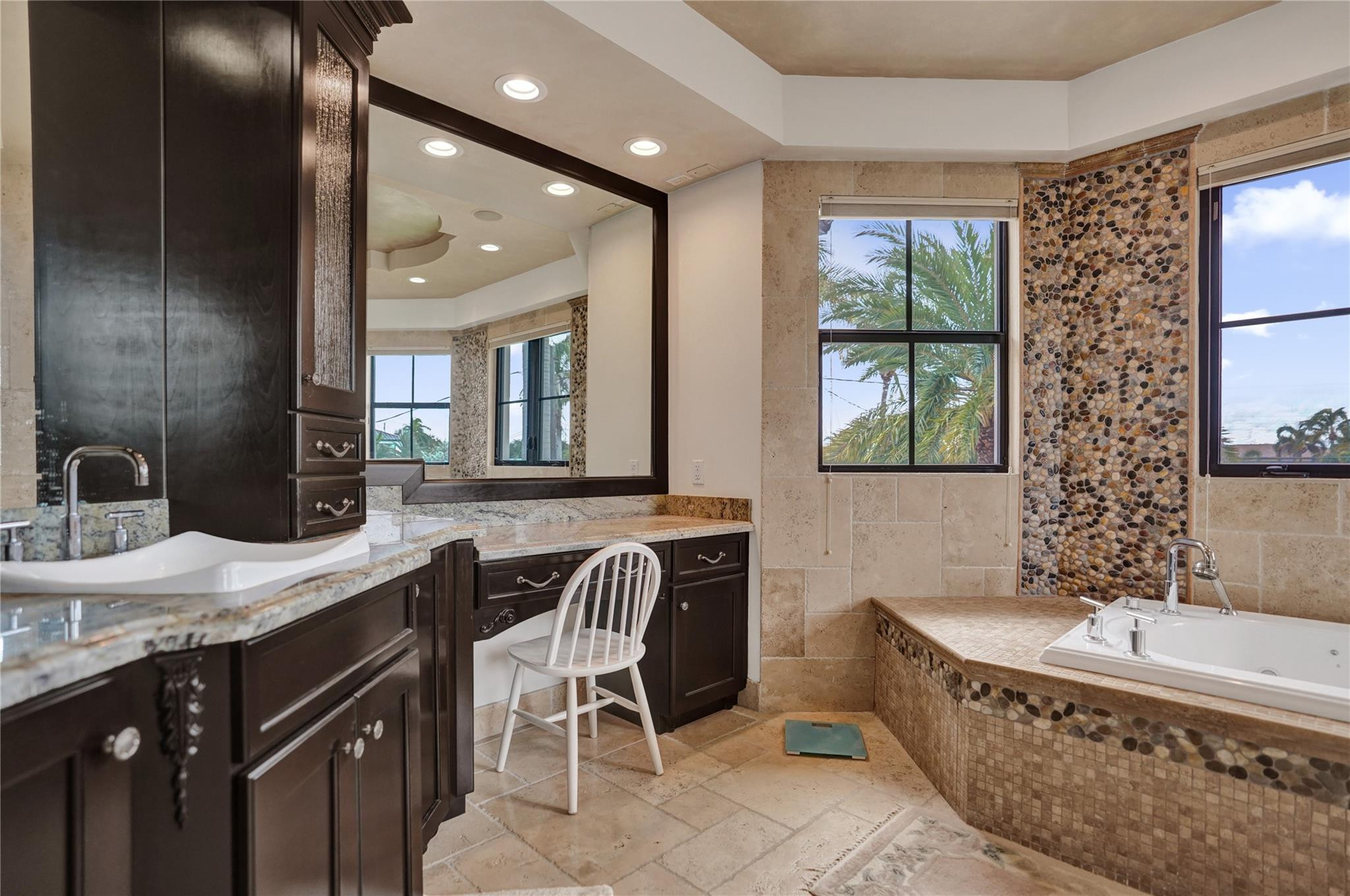 4930 Northeast 27th Terrace Lighthouse Point, FL 33064 - Photo 28 of 51 a bathroom with a granite countertop tub a sink and a large mirror