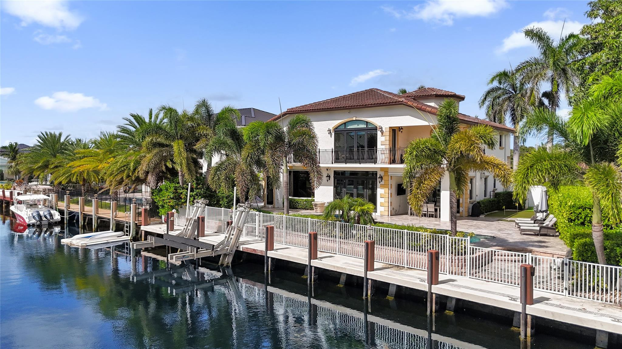 4930 Northeast 27th Terrace Lighthouse Point, FL 33064 - Photo 37 of 51 a front view of a house with swimming pool and patio