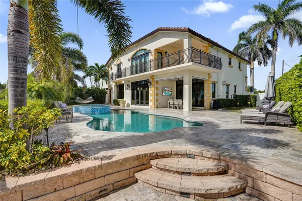 a view of a house with a yard and potted plants