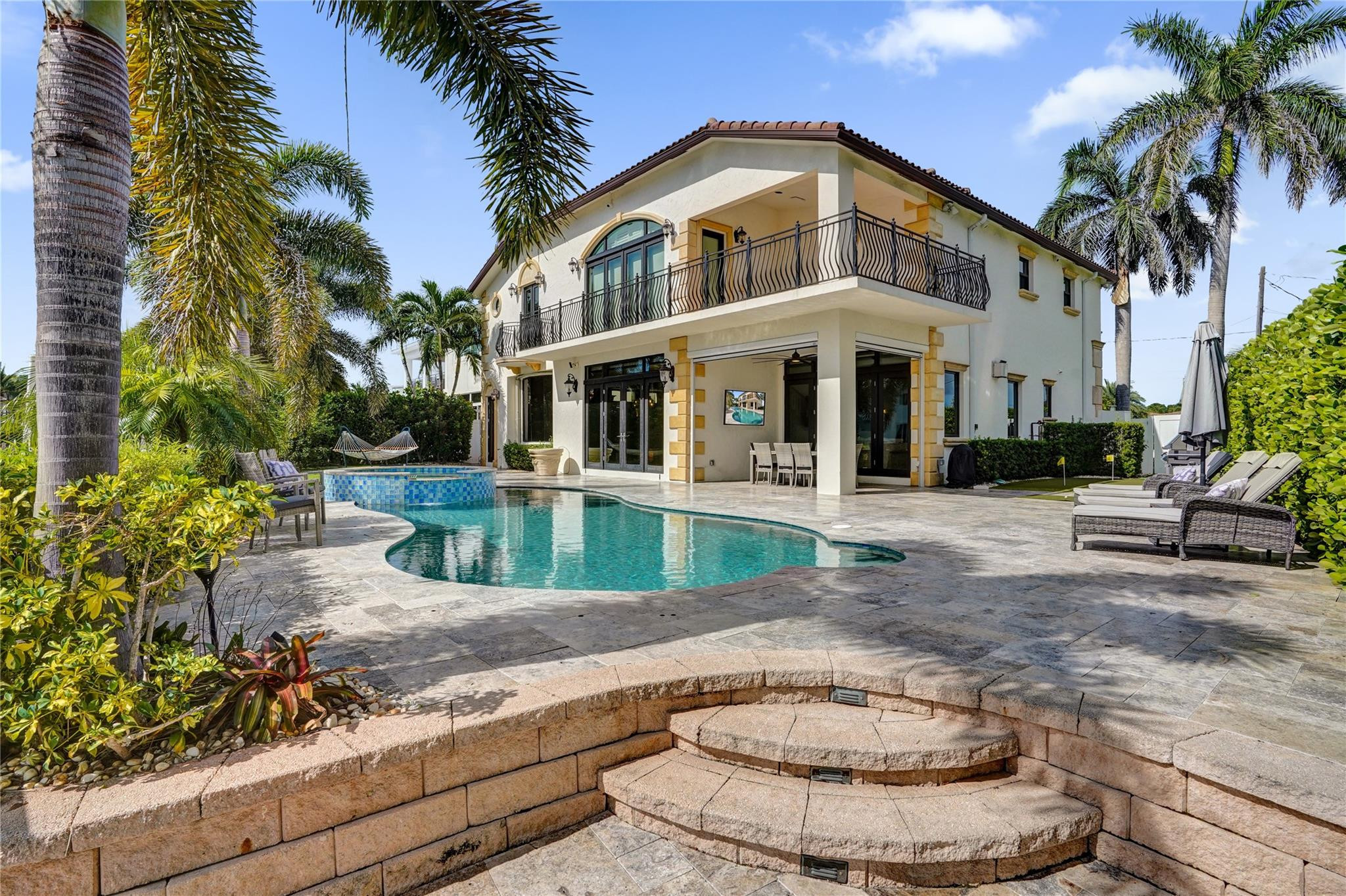 4930 Northeast 27th Terrace Lighthouse Point, FL 33064 - Photo 38 of 51 a view of a white house with a fountain and a fountain