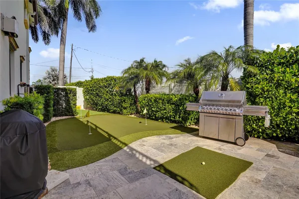a view of a house with backyard water slide and sitting area