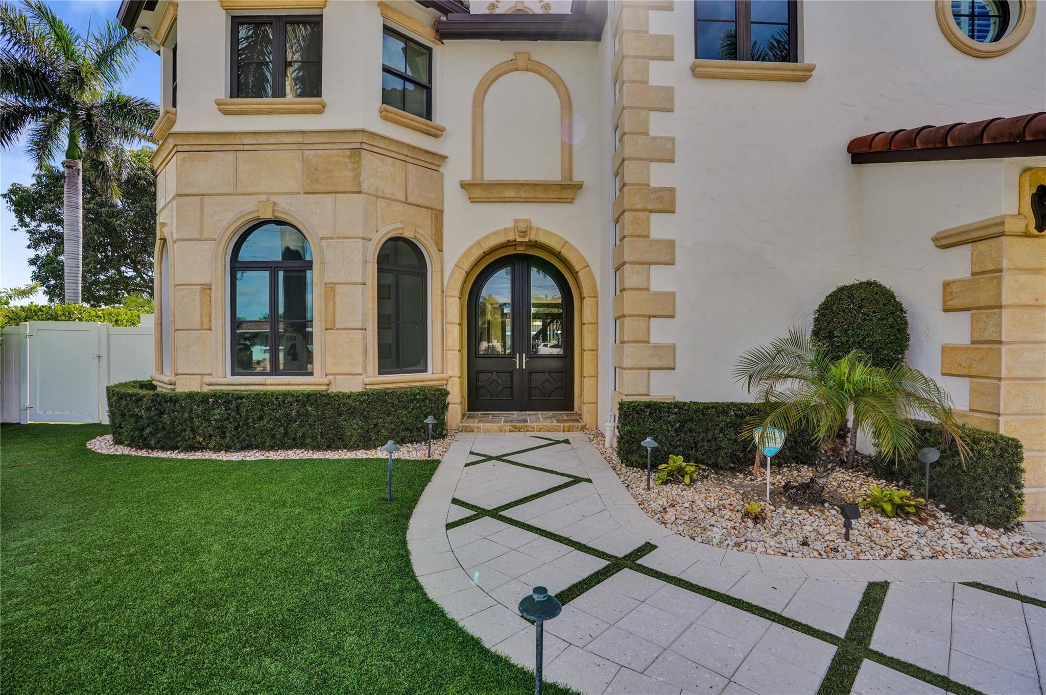 4930 Northeast 27th Terrace Lighthouse Point, FL 33064 - Photo 4 of 51 a front view of a house with garden