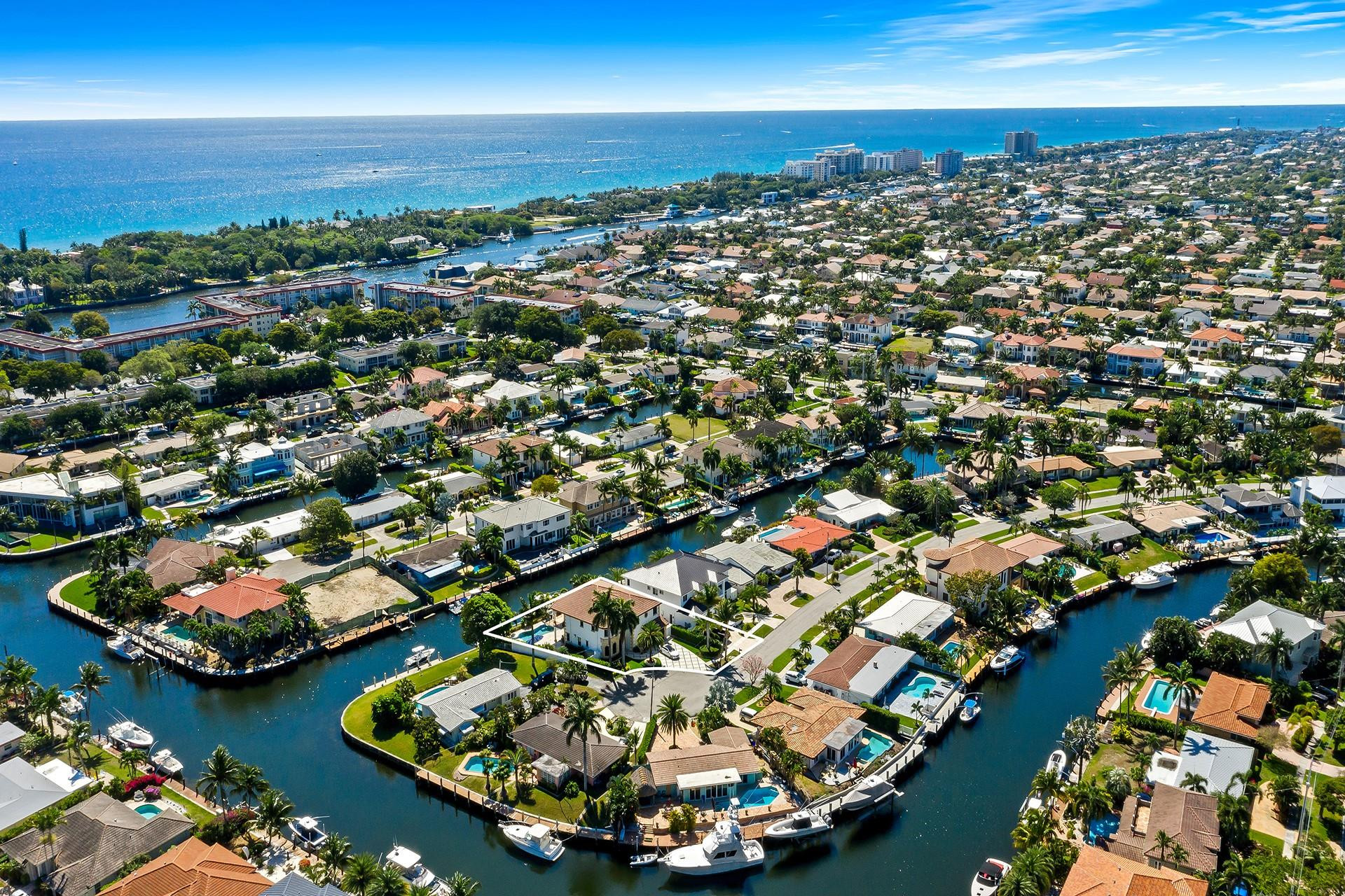 4930 Northeast 27th Terrace Lighthouse Point, FL 33064 - Photo 49 of 51 an aerial view of a city with lots of residential buildings ocean and mountain view in back