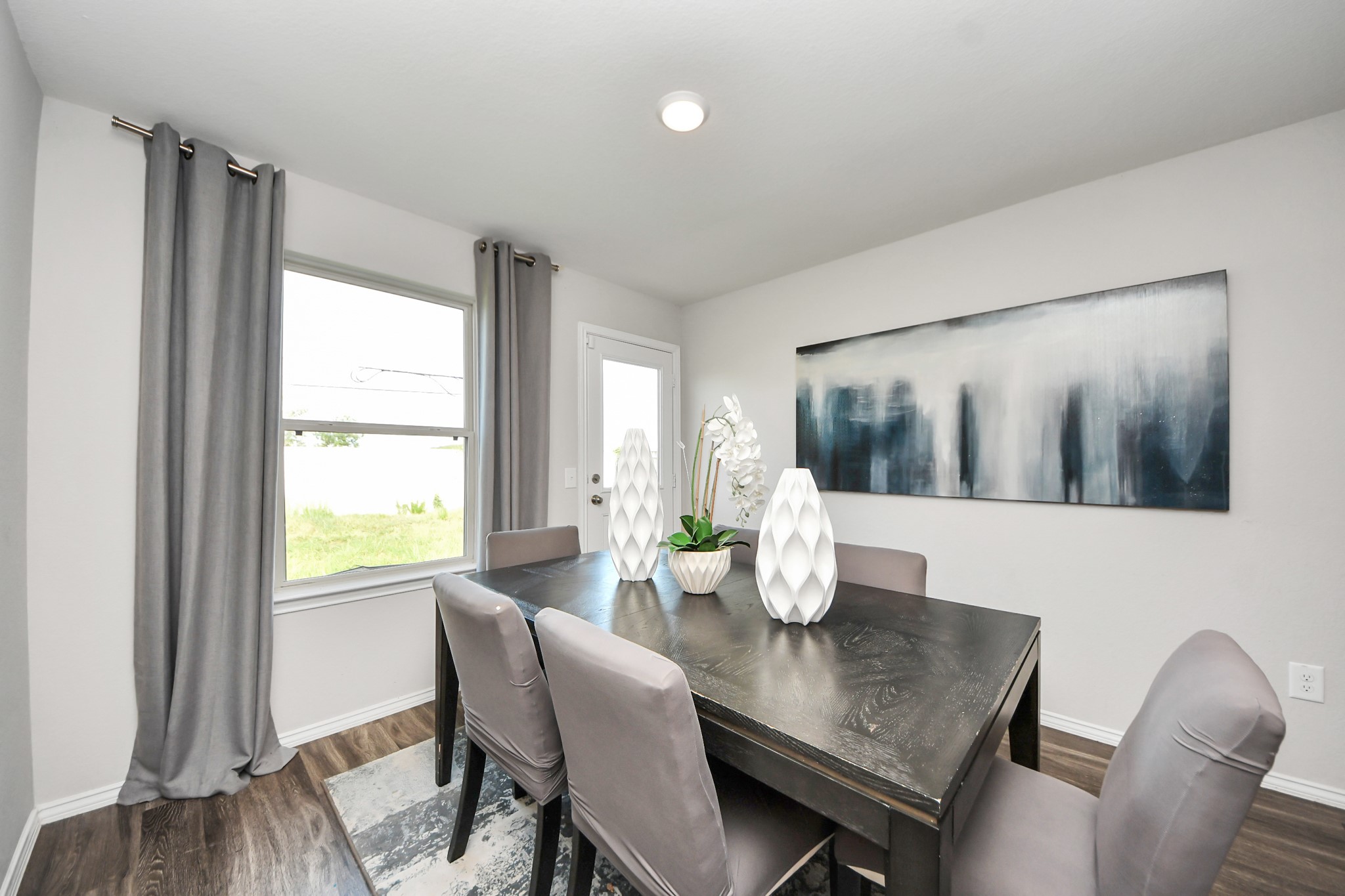 5735 Prairie Chapel Road Katy, TX 77493 - Photo 11 of 19 a dining room with furniture and wooden floor