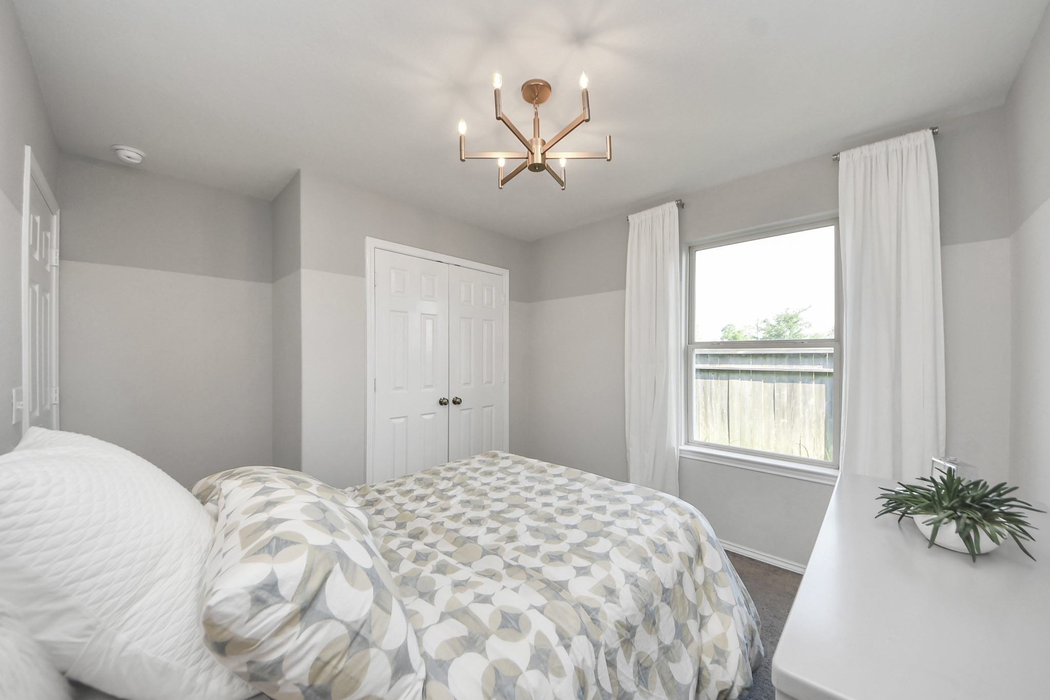 5735 Prairie Chapel Road Katy, TX 77493 - Photo 12 of 19 a bedroom with a large bed and a chandelier