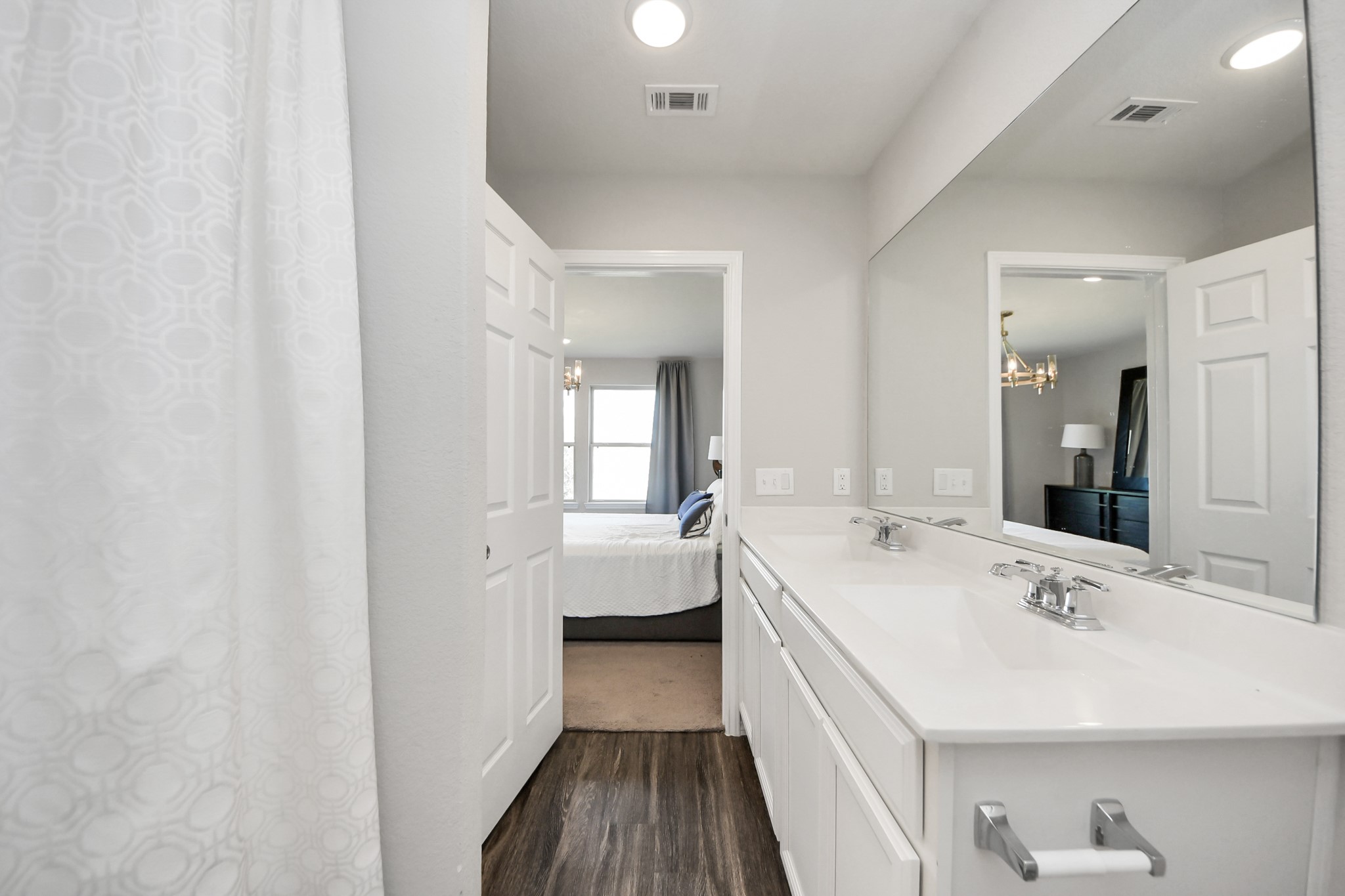 5735 Prairie Chapel Road Katy, TX 77493 - Photo 16 of 19 a large white room with a double vanity sink and mirror