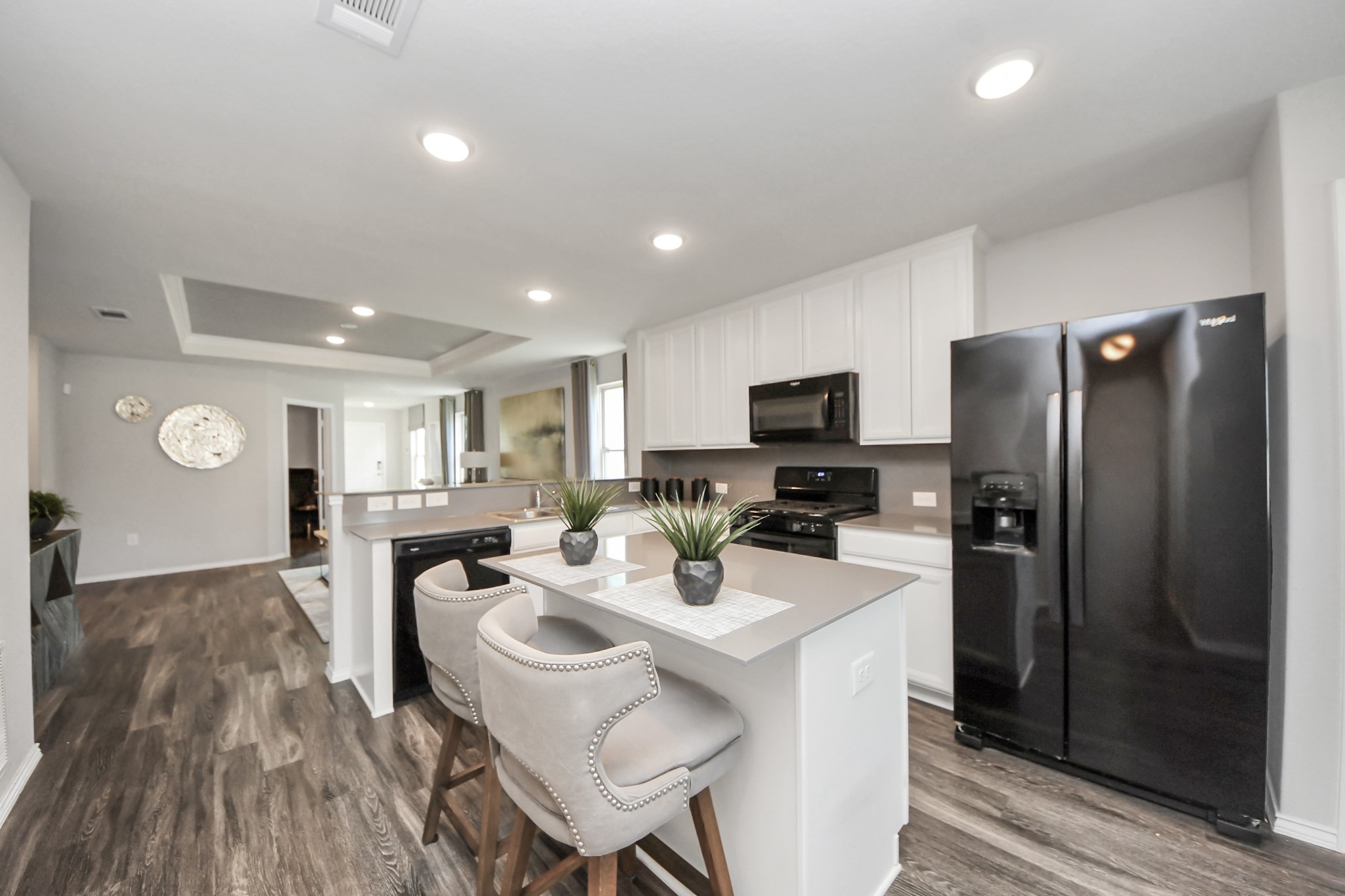 5735 Prairie Chapel Road Katy, TX 77493 - Photo 10 of 19 a kitchen with stainless steel appliances granite countertop a refrigerator a stove a sink a dining table and chairs with wooden floor