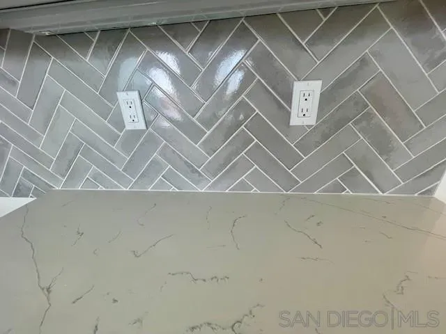 a large white kitchen with a sink and dishwasher