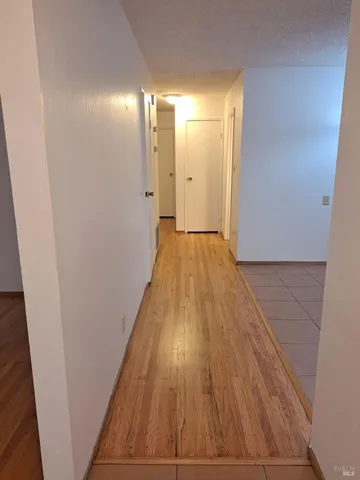 a view of a room with wooden floor and a balcony