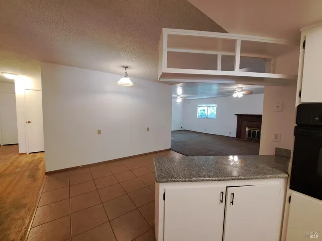 a kitchen with granite countertop a sink and a stove
