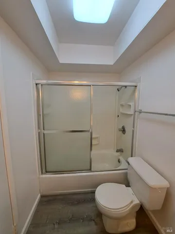 a bathroom with a toilet and a shower