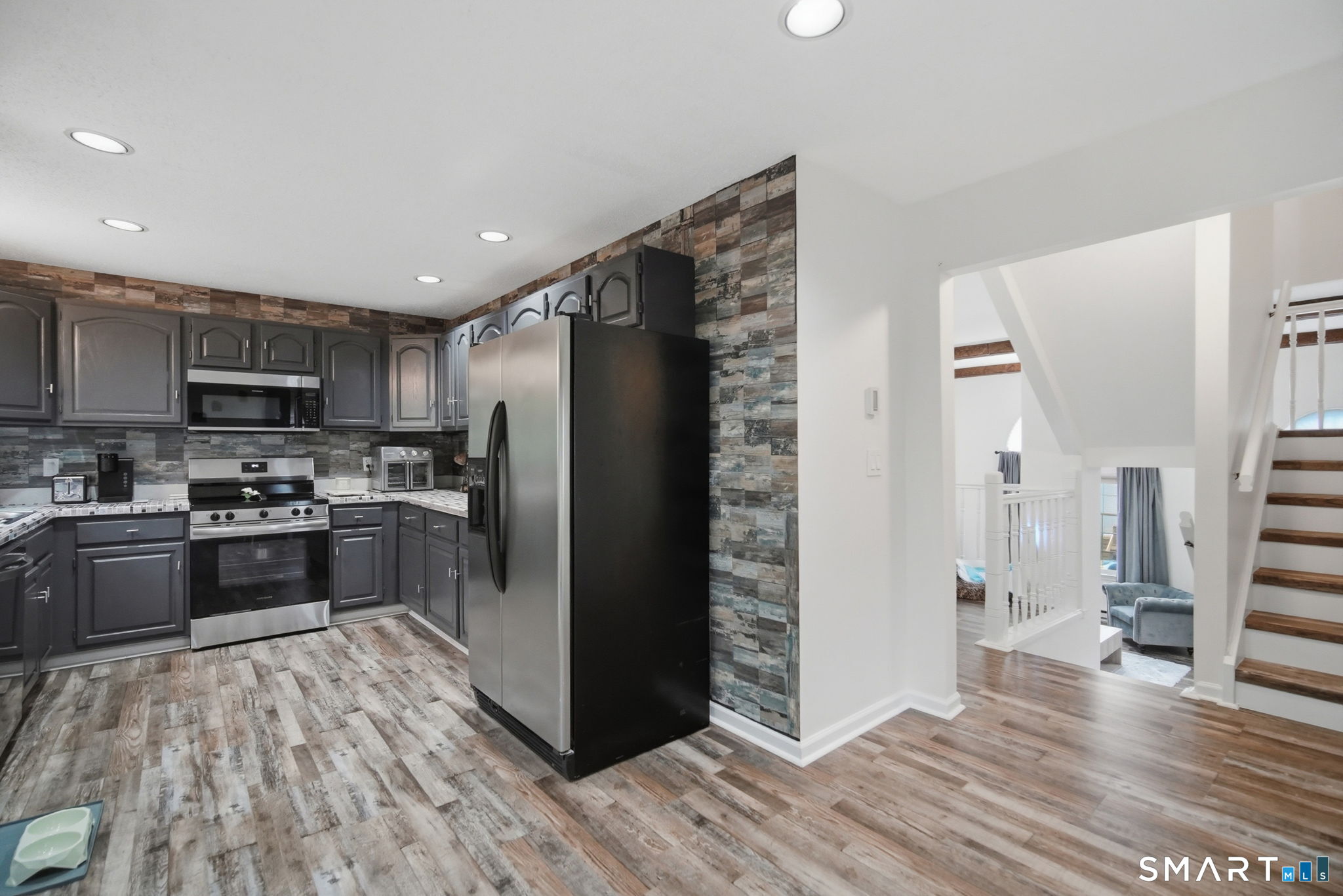 350 Bristol Street, Unit C12 Waterbury, CT 06708 - Photo 12 of 40 a kitchen with stainless steel appliances granite countertop a refrigerator stove and oven