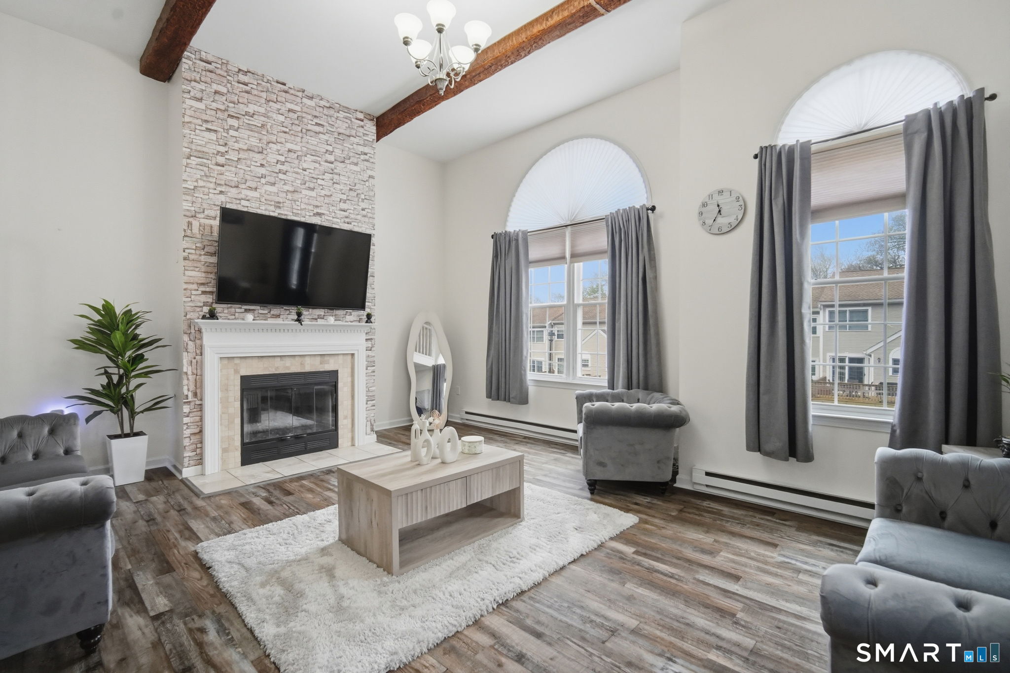 350 Bristol Street, Unit C12 Waterbury, CT 06708 - Photo 32 of 40 a living room with furniture a flat screen tv and a fireplace