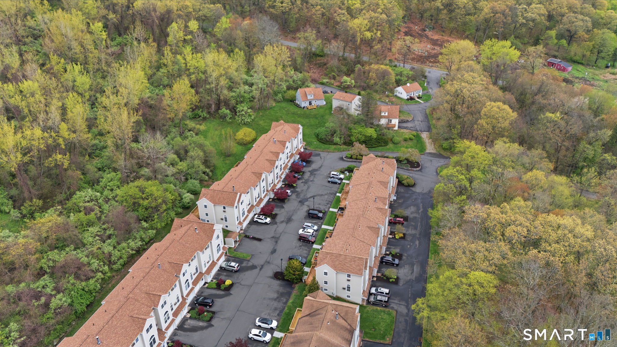 350 Bristol Street, Unit C12 Waterbury, CT 06708 - Photo 33 of 40 an aerial view of a residential apartment building with a yard