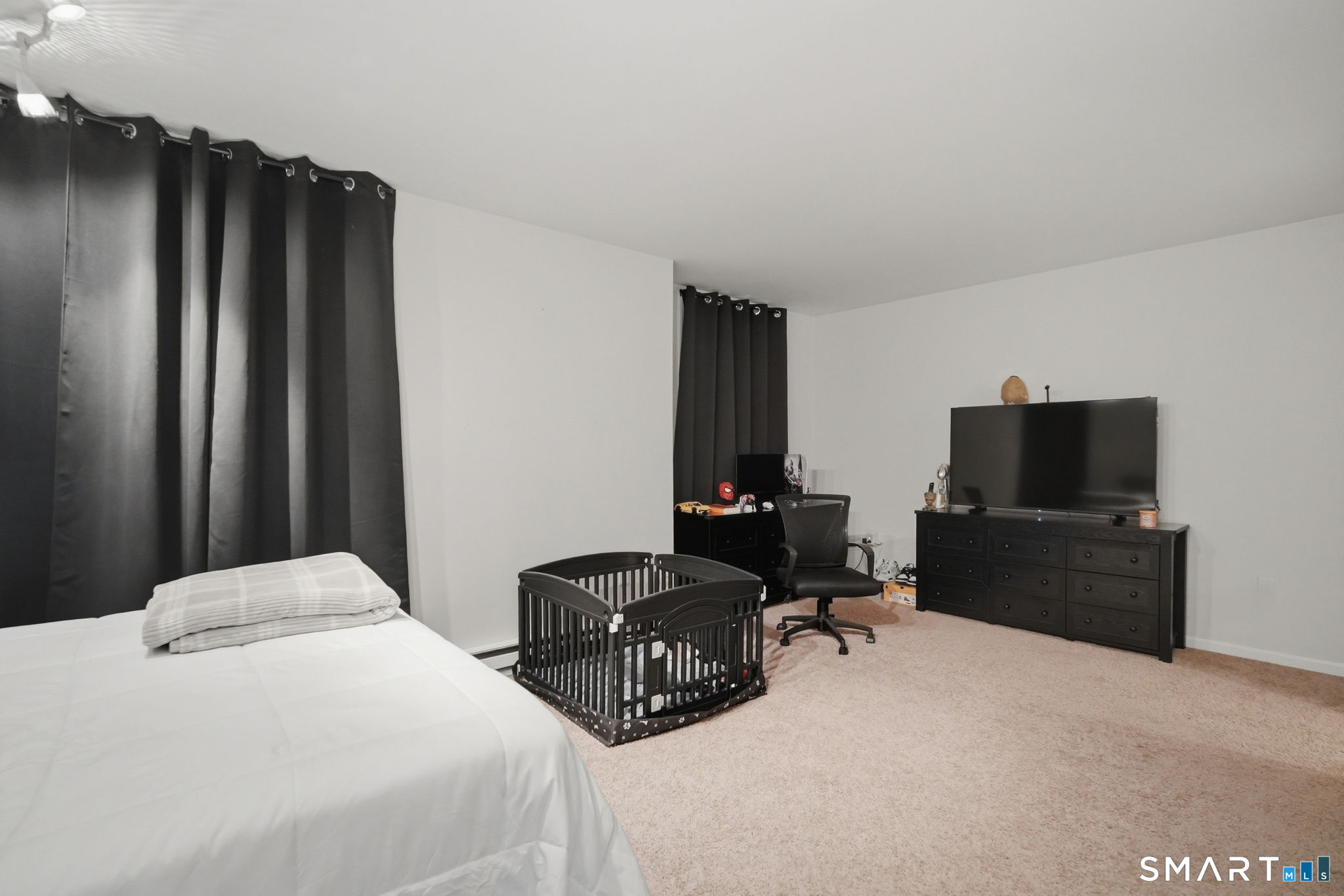 350 Bristol Street, Unit C12 Waterbury, CT 06708 - Photo 6 of 40 a bedroom with a bed and a flat screen tv