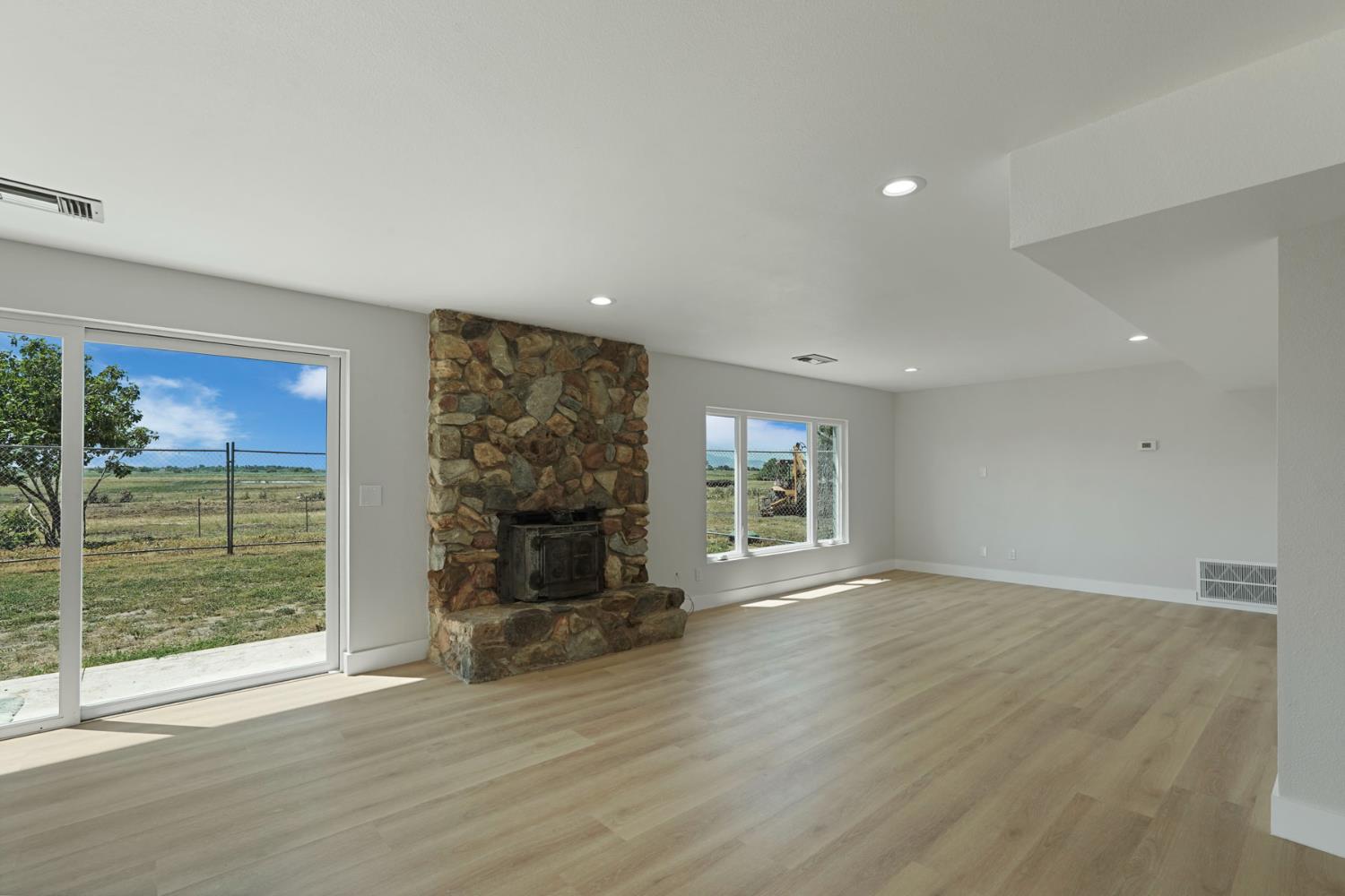 2650 West Twitchell Island Road Rio Vista, CA 94571 - Photo 41 of 60 a view of empty room with wooden floor and fireplace