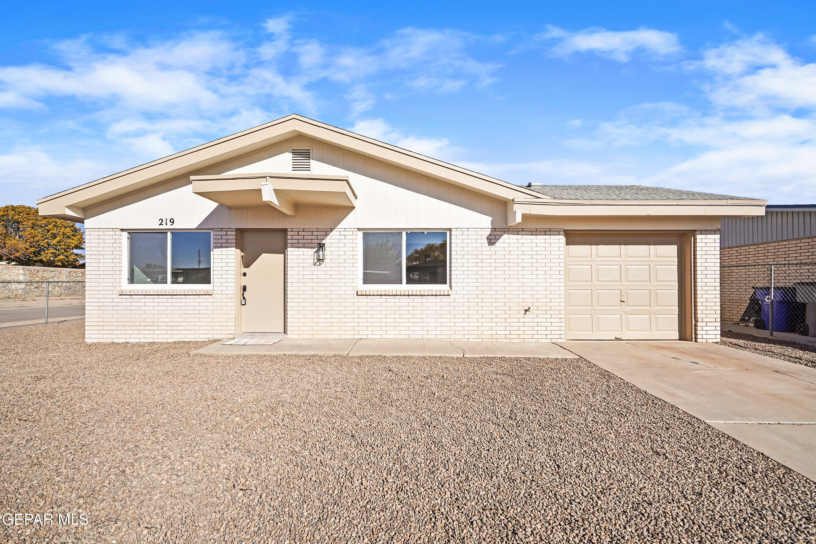 a front view of a house with a garage