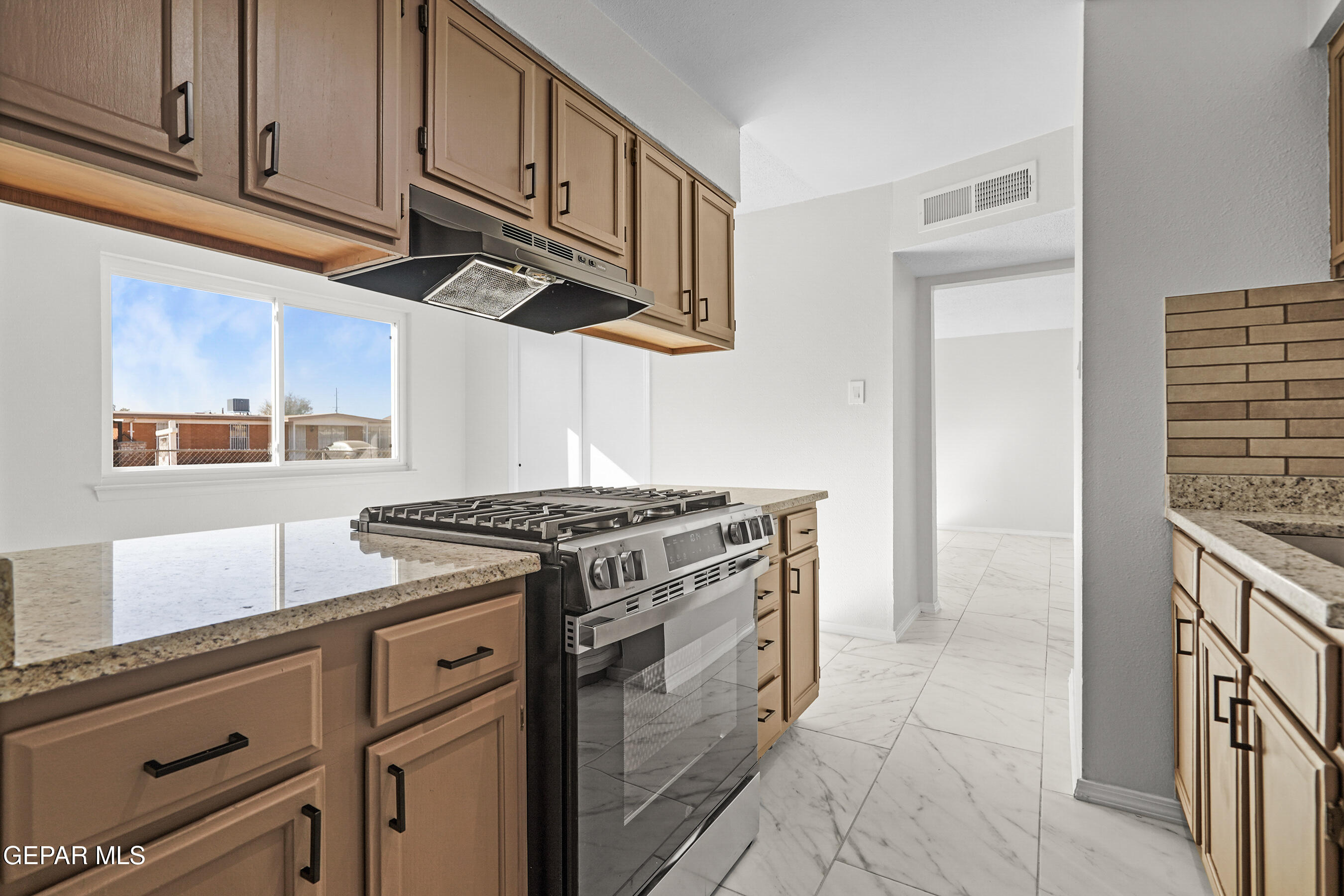 219 Caribe Circle El Paso, TX 79927 - Photo 14 of 43 a kitchen with stainless steel appliances granite countertop a stove and a sink