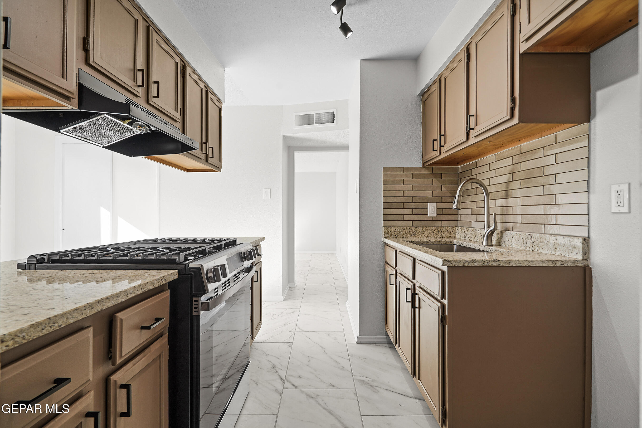 219 Caribe Circle El Paso, TX 79927 - Photo 15 of 43 a kitchen with stainless steel appliances granite countertop a stove and a sink