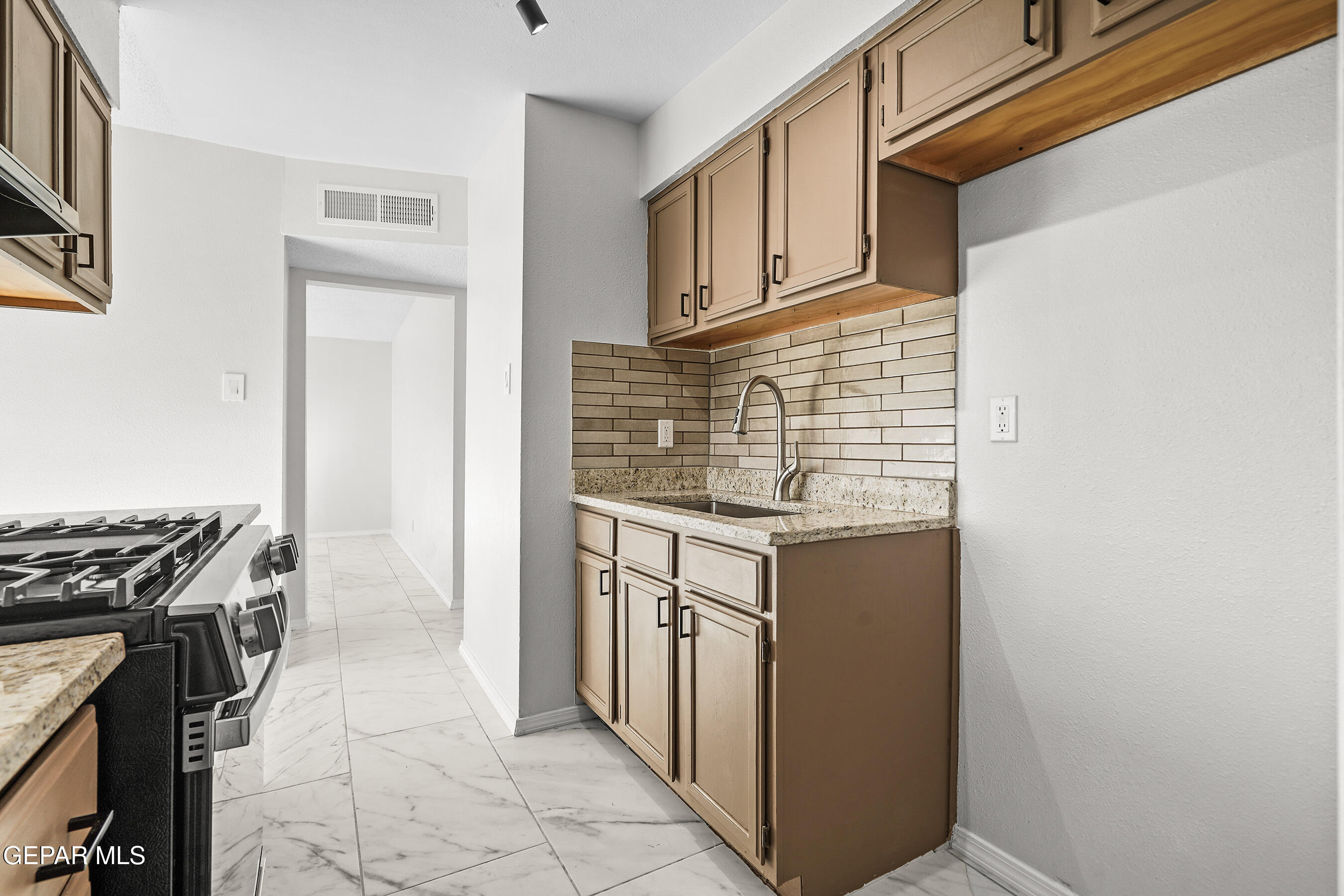 219 Caribe Circle El Paso, TX 79927 - Photo 16 of 43 a kitchen with stainless steel appliances granite countertop a stove and a refrigerator