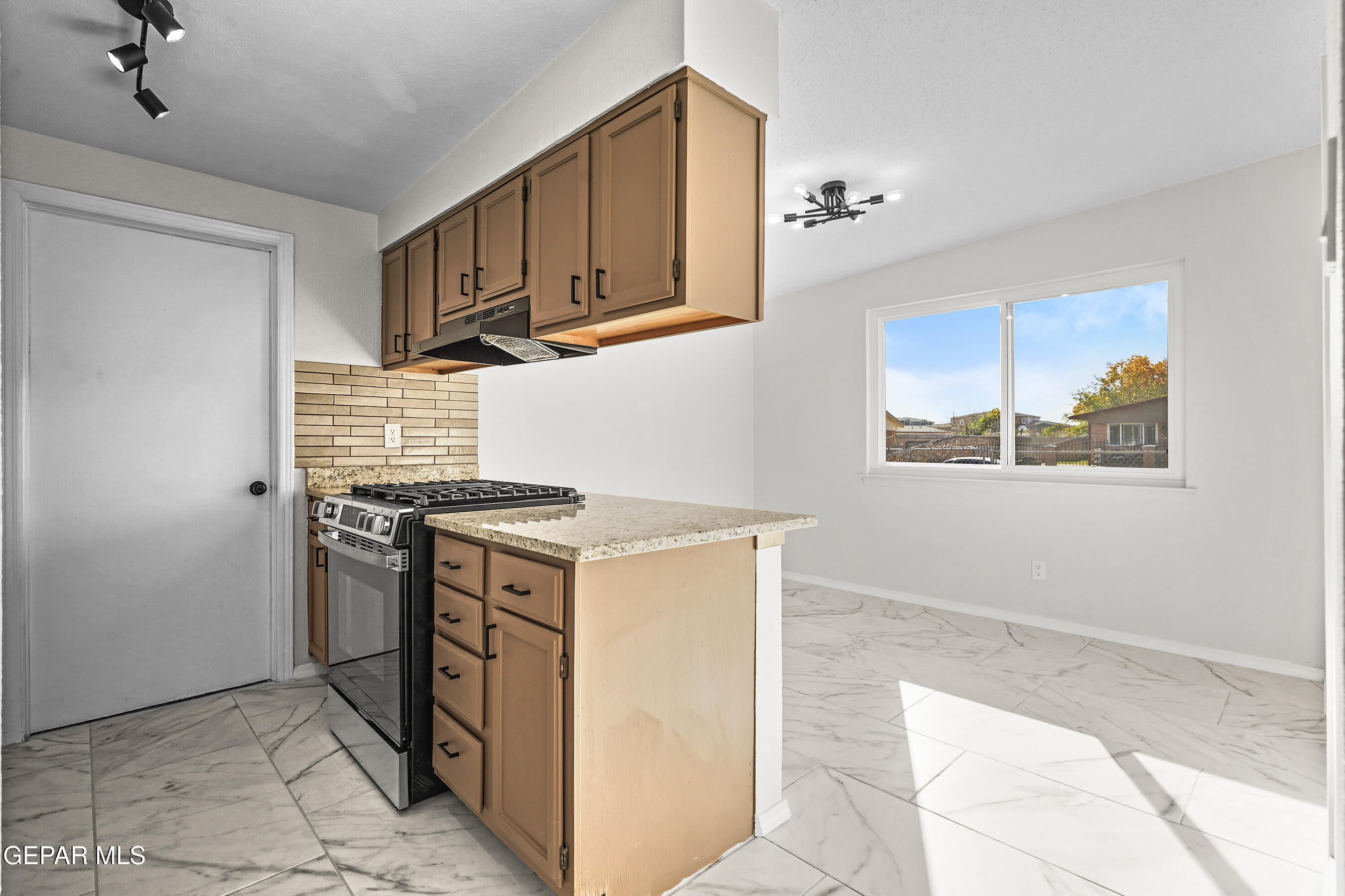 219 Caribe Circle El Paso, TX 79927 - Photo 17 of 43 a kitchen with stainless steel appliances granite countertop a stove and a refrigerator