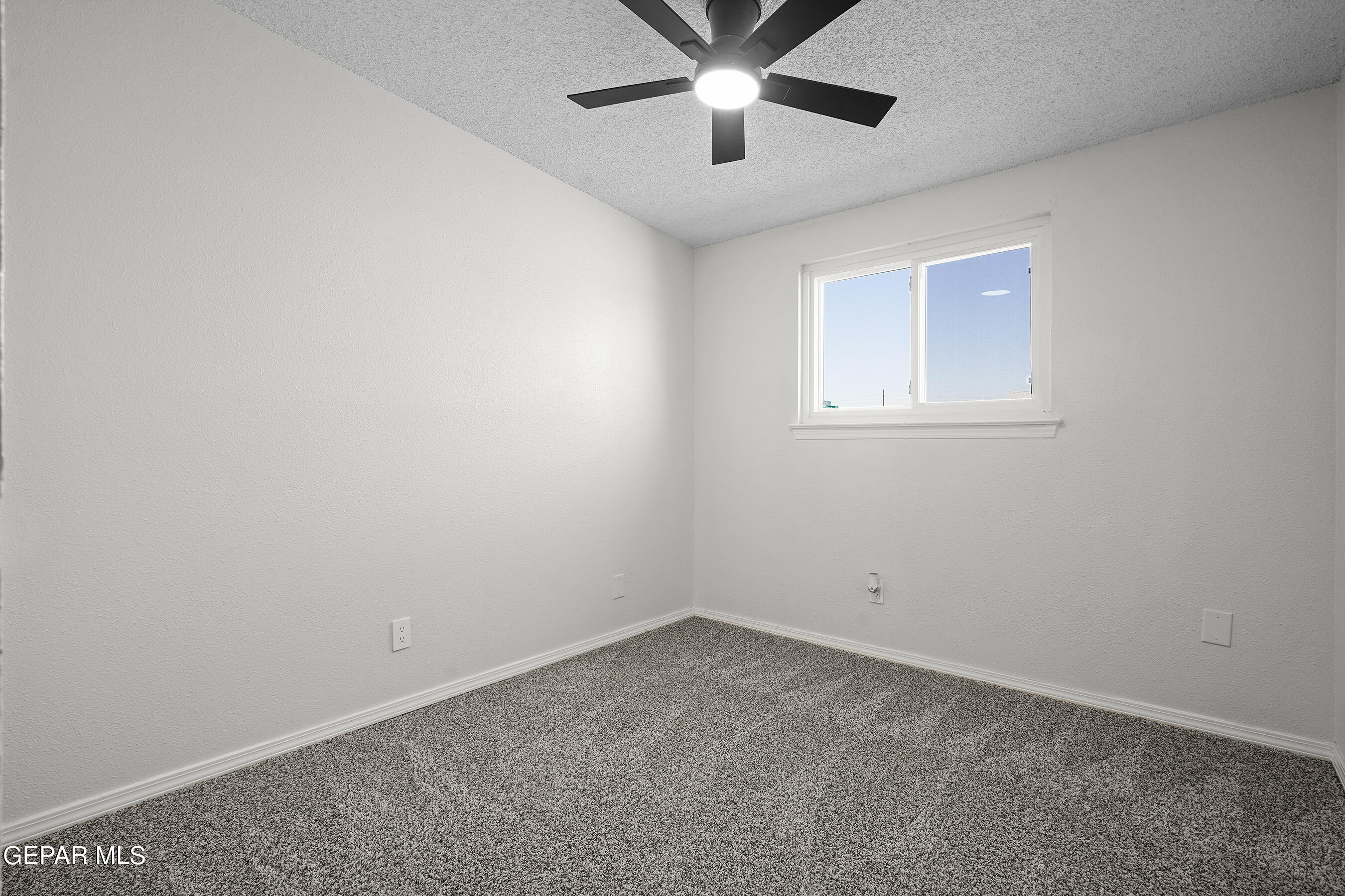 219 Caribe Circle El Paso, TX 79927 - Photo 29 of 43 an empty room with a window and a fan