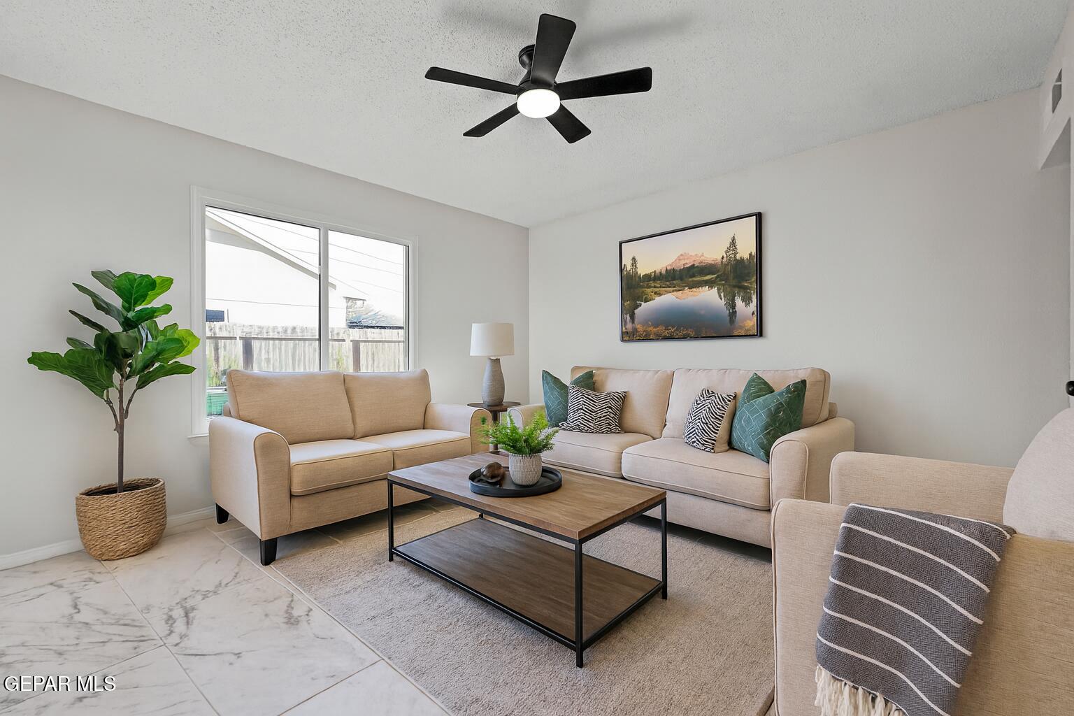 219 Caribe Circle El Paso, TX 79927 - Photo 3 of 43 a living room with furniture a chandelier and a potted plant