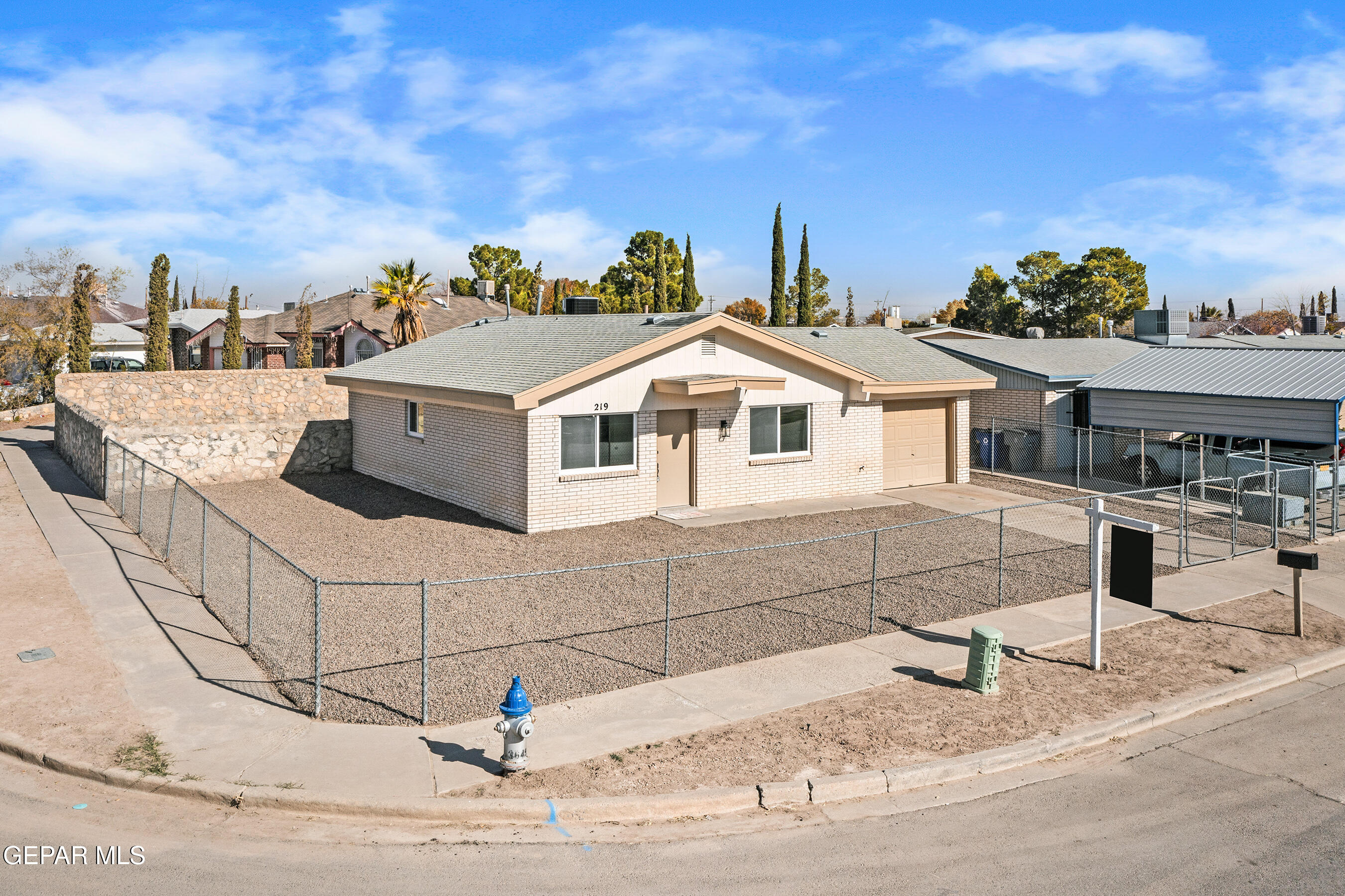219 Caribe Circle El Paso, TX 79927 - Photo 9 of 43 a view of a white house with a yard