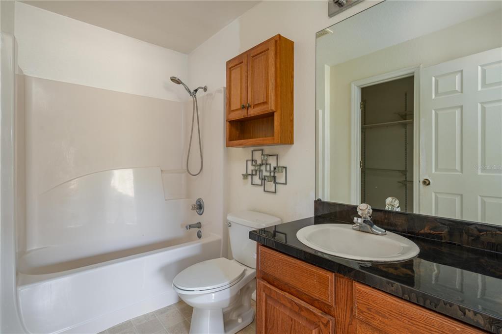 403 Southeast 3rd Street Fort Meade, FL 33841 - Photo 12 of 30 a bathroom with a granite countertop sink toilet and shower