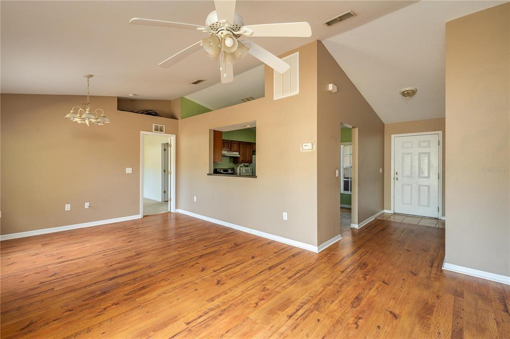 403 Southeast 3rd Street Fort Meade, FL 33841 - Photo 4 of 30 a view of a livingroom with a ceiling fan window and wooden floor