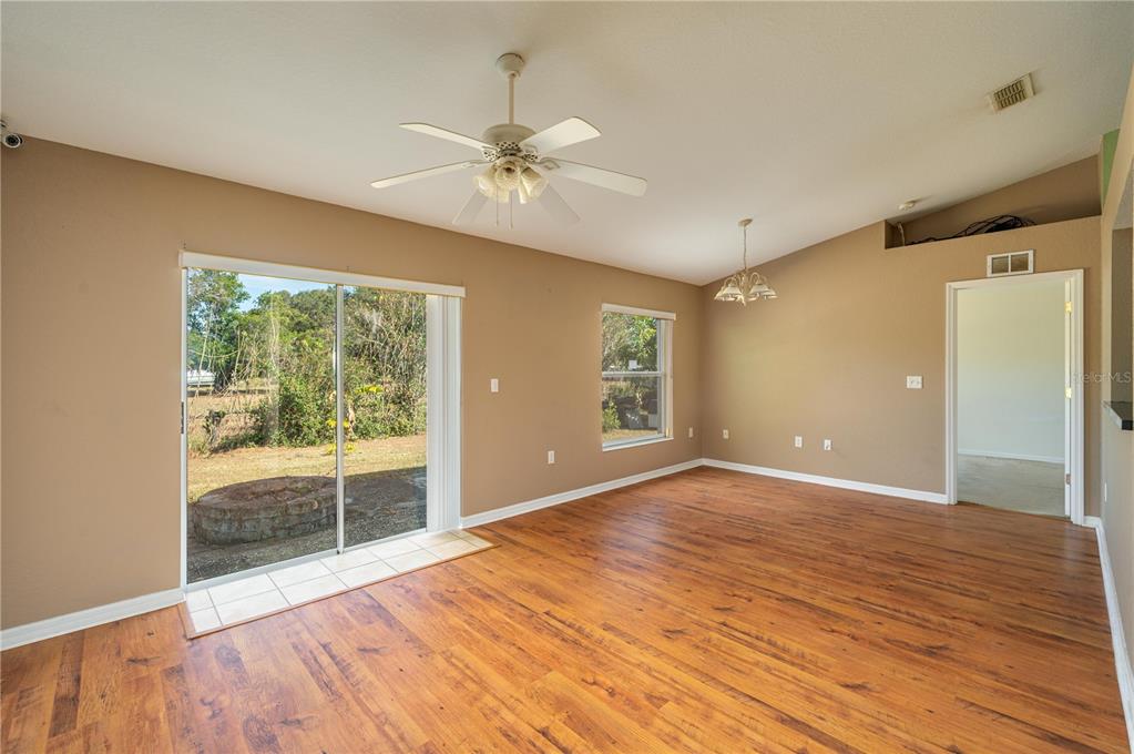 403 Southeast 3rd Street Fort Meade, FL 33841 - Photo 5 of 30 a view of an empty room with a window and wooden floor