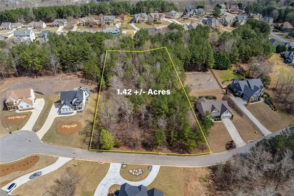 an aerial view of a house with a yard basket ball court